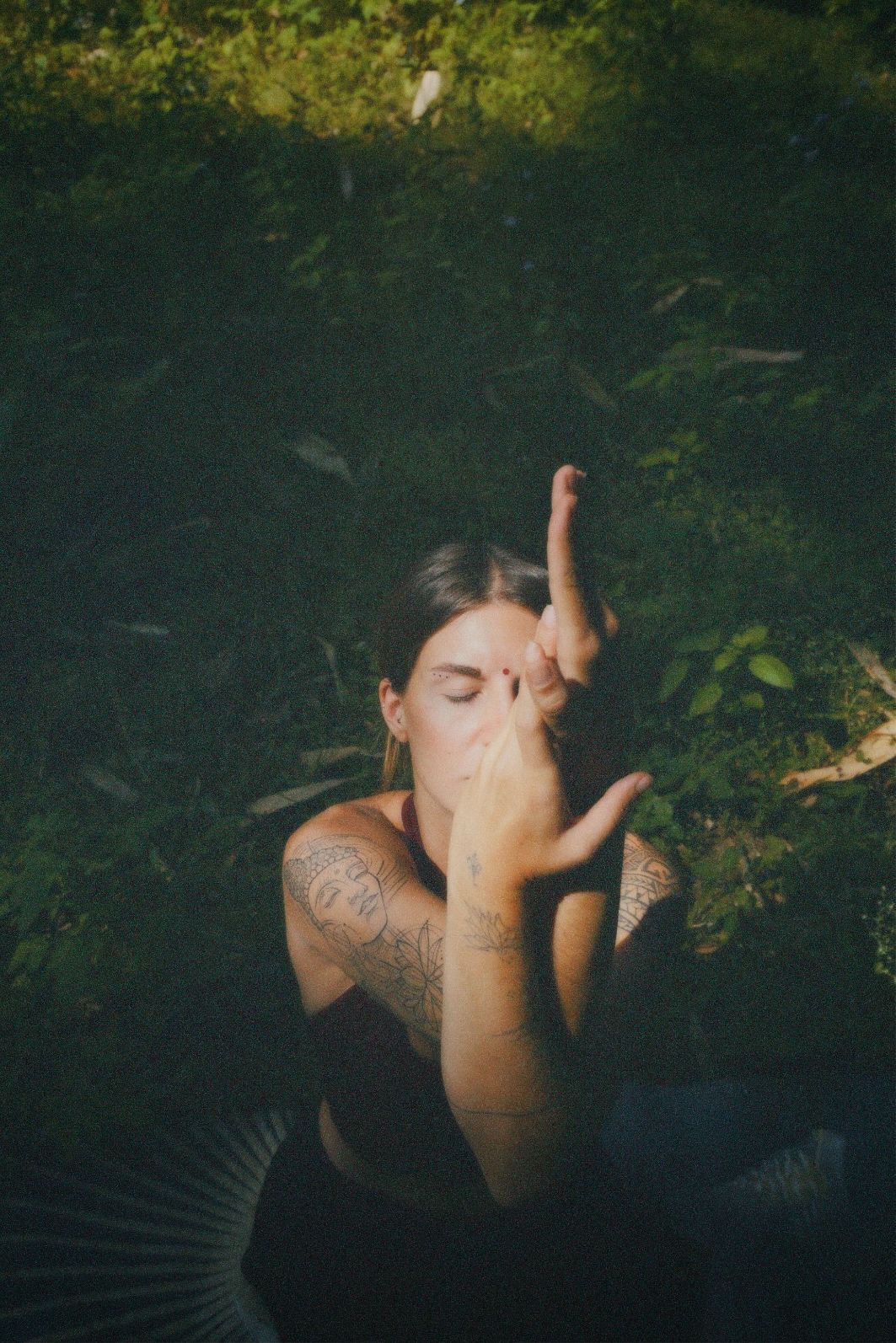 Mujer en meditación entre follaje